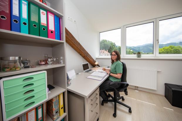 view of residence room with desk and storage 